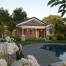 A house with flowers around the pool and trees.