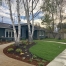 A house with a garden and trees in the background