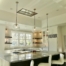 A kitchen with white walls and black counter tops.