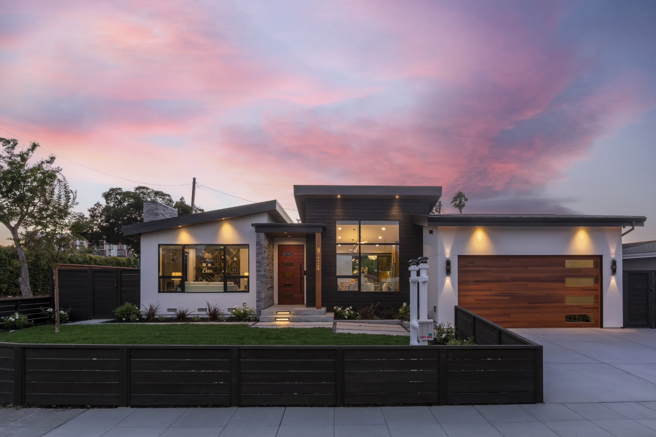 A modern home with sunset in the background.