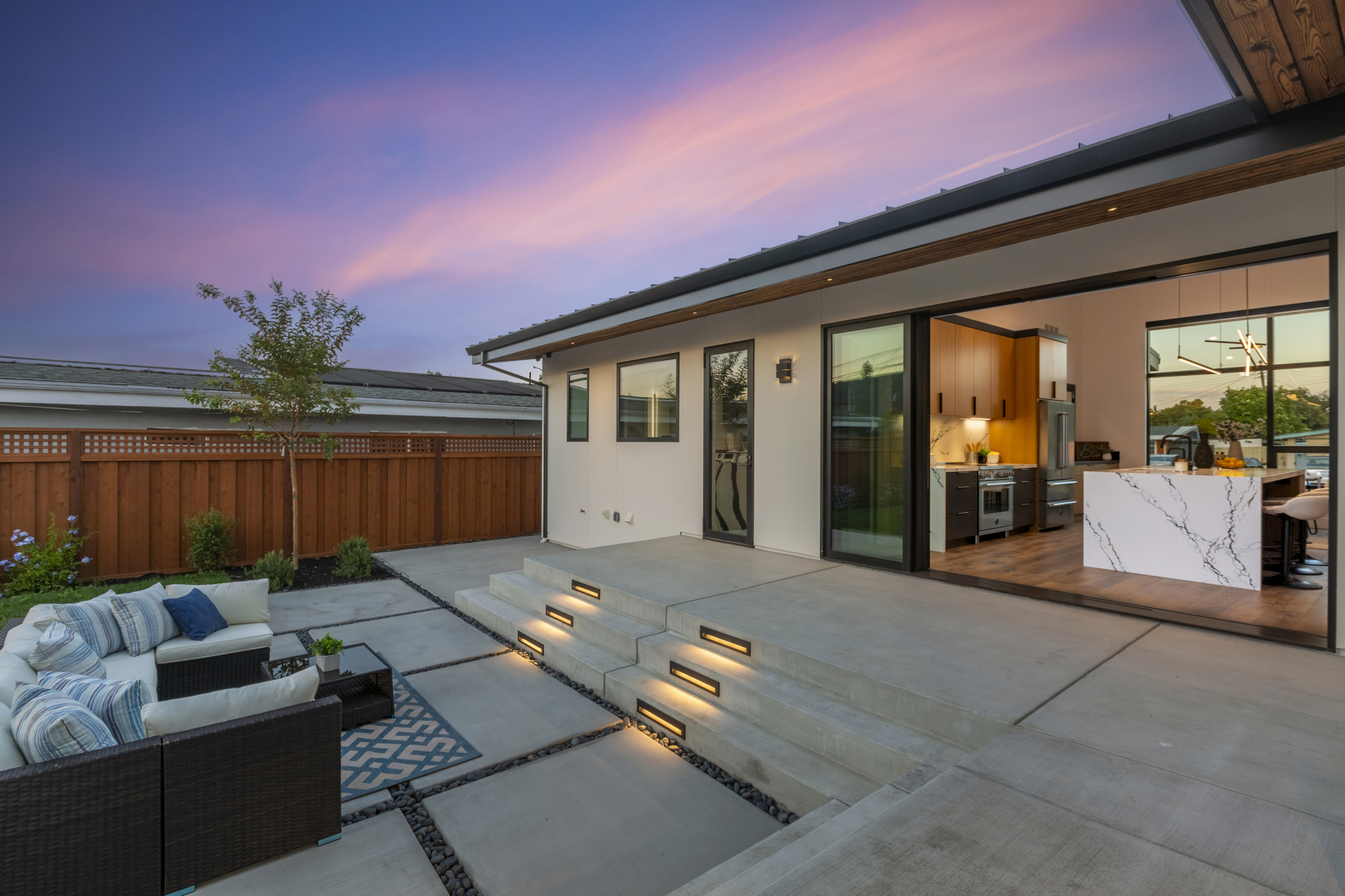 A patio with steps leading to the back yard.